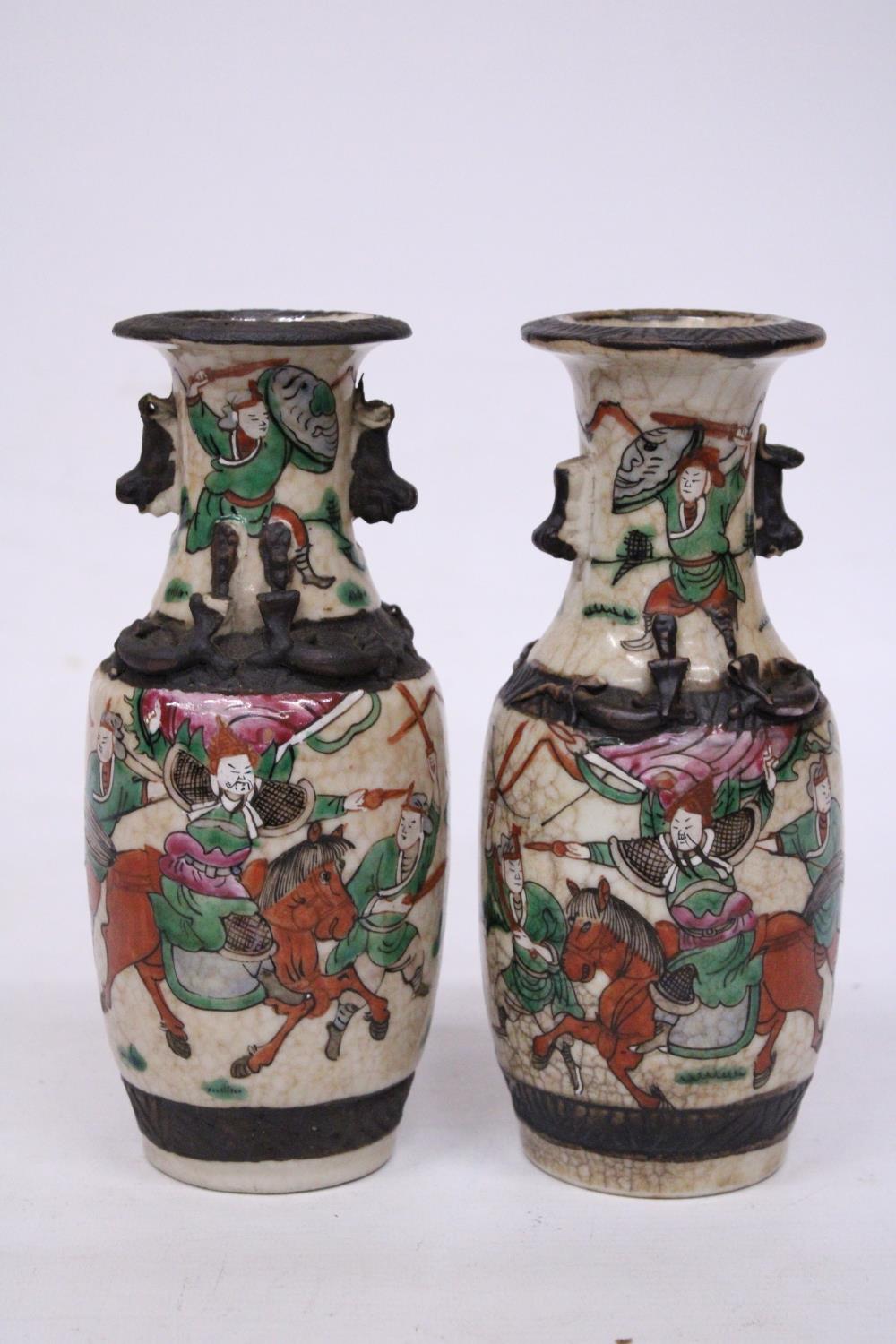 A PAIR OF CHINESE CRACKLE GLAZED VASES WITH WARRIOR SCENES - 18 CM (H) - MARK TO BASE
