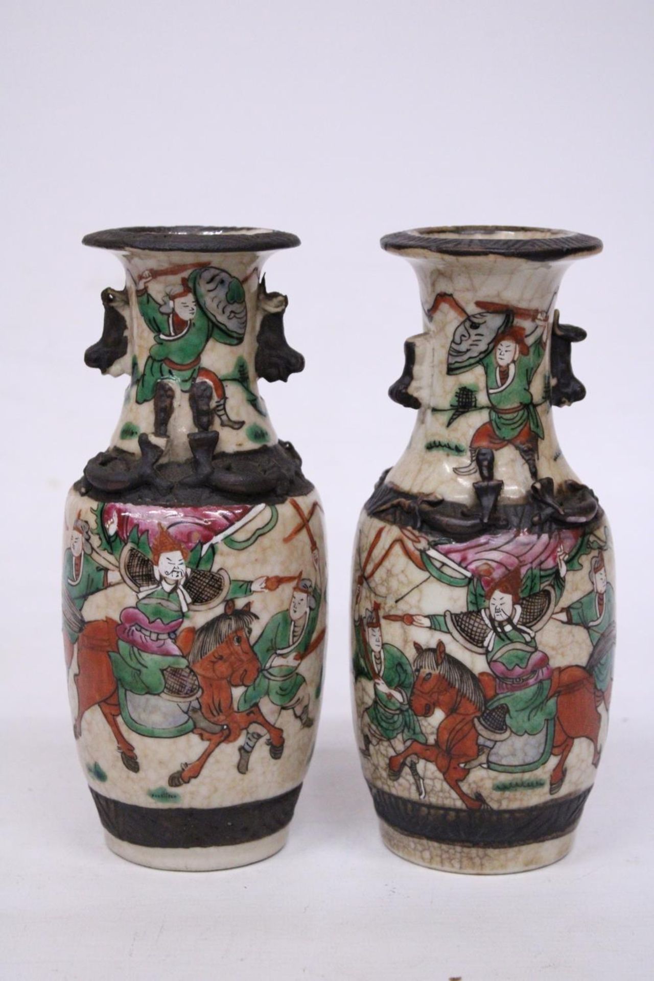 A PAIR OF CHINESE CRACKLE GLAZED VASES WITH WARRIOR SCENES - 18 CM (H) - MARK TO BASE