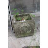 A SMALL RECONSTITUTED STONE PLANTER