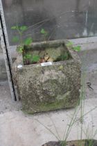 A SMALL RECONSTITUTED STONE PLANTER