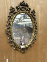 AN ARCHED GILT FRAMED MIRROR