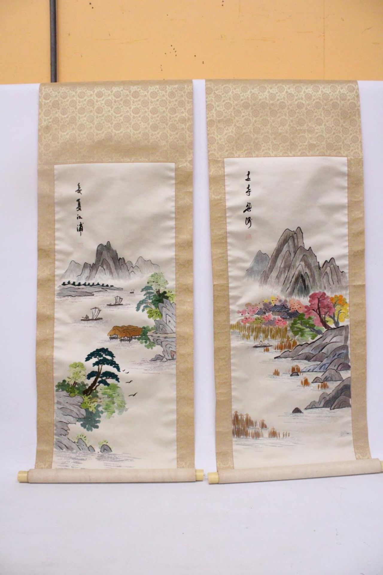 A PAIR OF VINTAGE JAPANESE HANGING SCROLLS WITH SILK EMBROIDERED LANDSCAPE SCENES