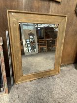 A RECTANGULAR OAK FRAMED WALL MIRROR, 51" X 42"