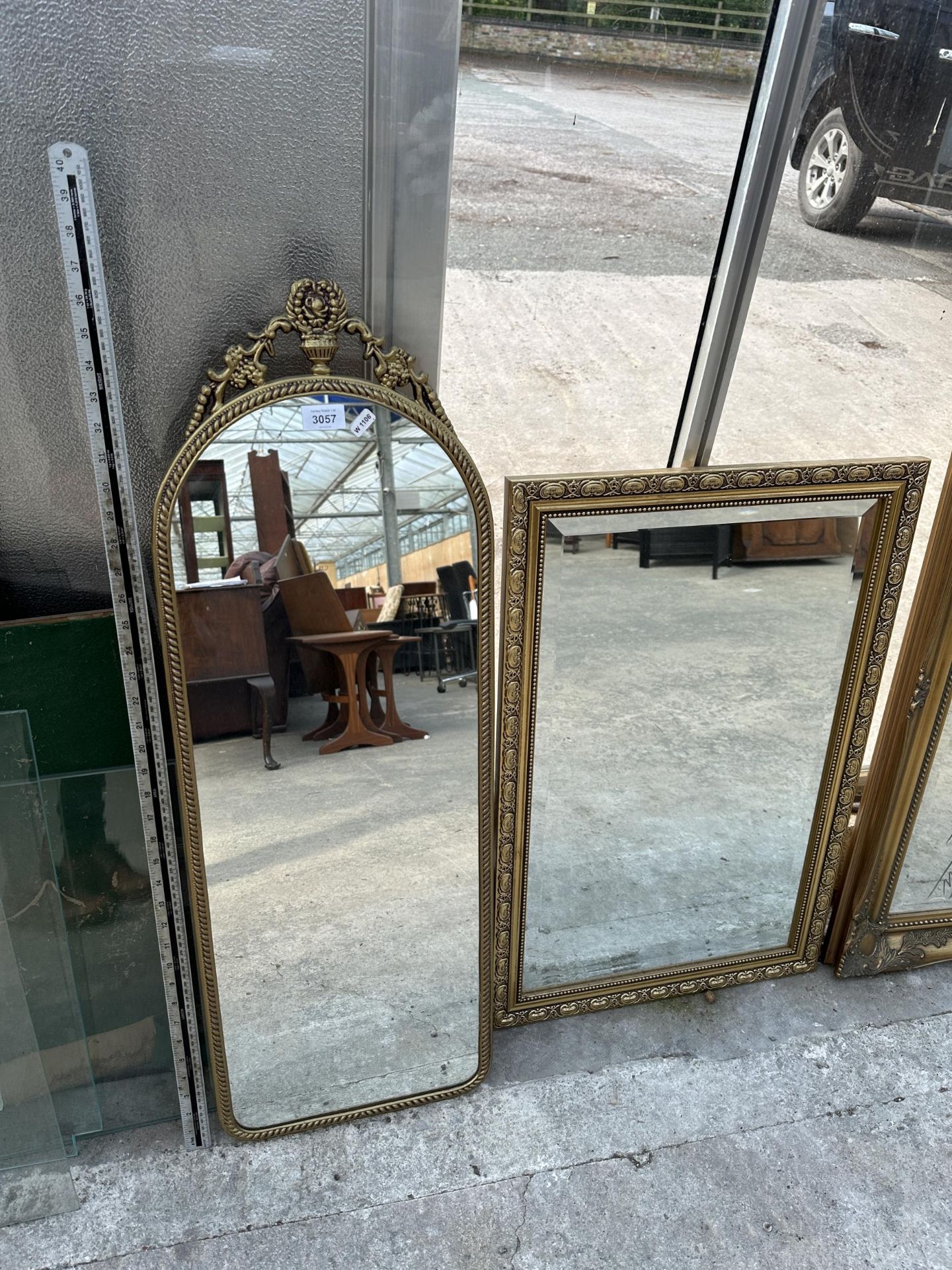 TWO GILT FRAMED MIRRORS - ONE RECTANGULAR, ONE WITH DECORATIVE ARCHED TOP