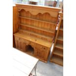 A VICTORIAN STYLE PINE KITCHEN DRESSER WITH PLATE RACK ENCLOSING SEVEN SPICE DRAWERS, THE BASE