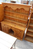 A VICTORIAN STYLE PINE KITCHEN DRESSER WITH PLATE RACK ENCLOSING SEVEN SPICE DRAWERS, THE BASE