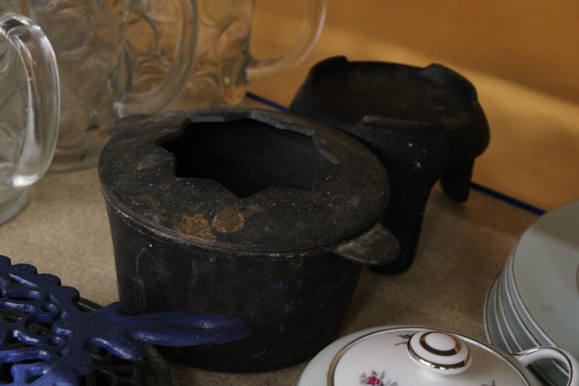 A CAST IRON COOK POT ON STAND PLUS TWO KETTLE STANDS AND CANDLE HOLDER - Image 2 of 4