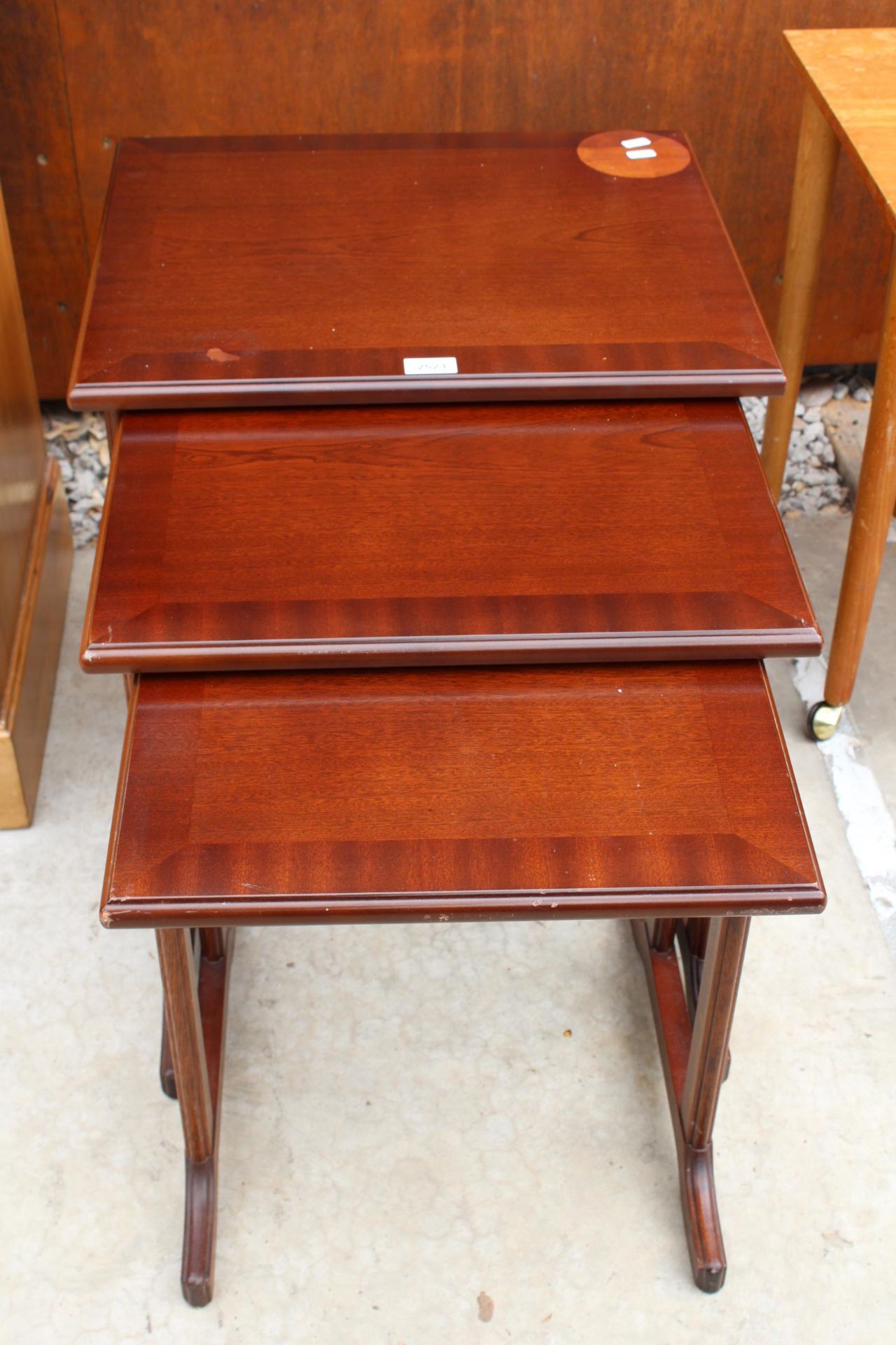 A NEST OF THREE MAHOGANY AND CROSSBANDED G.PLAN TABLES