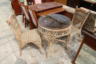 A MODERN WICKER AND BAMBOO 28" DIAMETER PATIO TABLE AND TWO CHAIRS