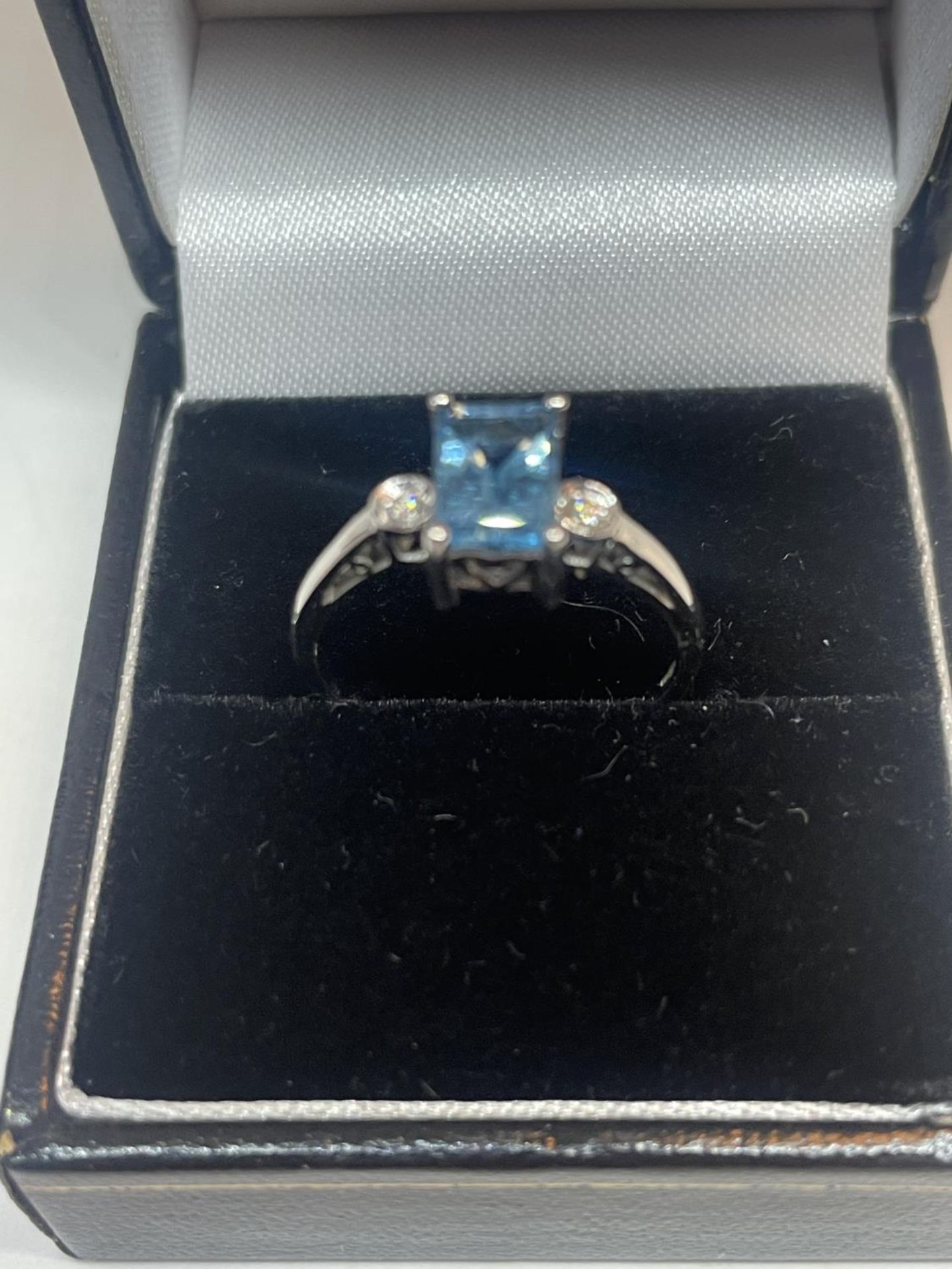 A 9 CARAT WHITE GOLD RING WITH A LARGE RECTANGULAR BLUE TOPAZ AND A DIAMOND EACH SIDE (EMERALD - Image 2 of 6