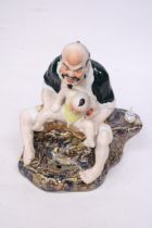 A CHINESE PORCELAIN MAN WITH BABY