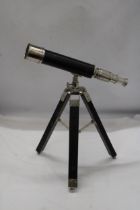 A CHROME TELESCOPE WITH TRIPOD STAND