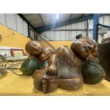 TWO LARGE CARVED HARDWOOD ORIENTAL FIGURES OF A SLEEPING BOY AND GIRL APPROXIMATELY 22CM TALL
