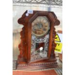 A DECORATIVE WOODEN CASED CHIMING MANTLE CLOCK