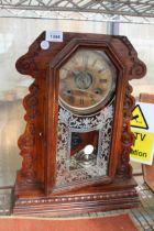 A DECORATIVE WOODEN CASED CHIMING MANTLE CLOCK