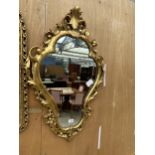 AN ORNATE GILT FRAMED MIRROR