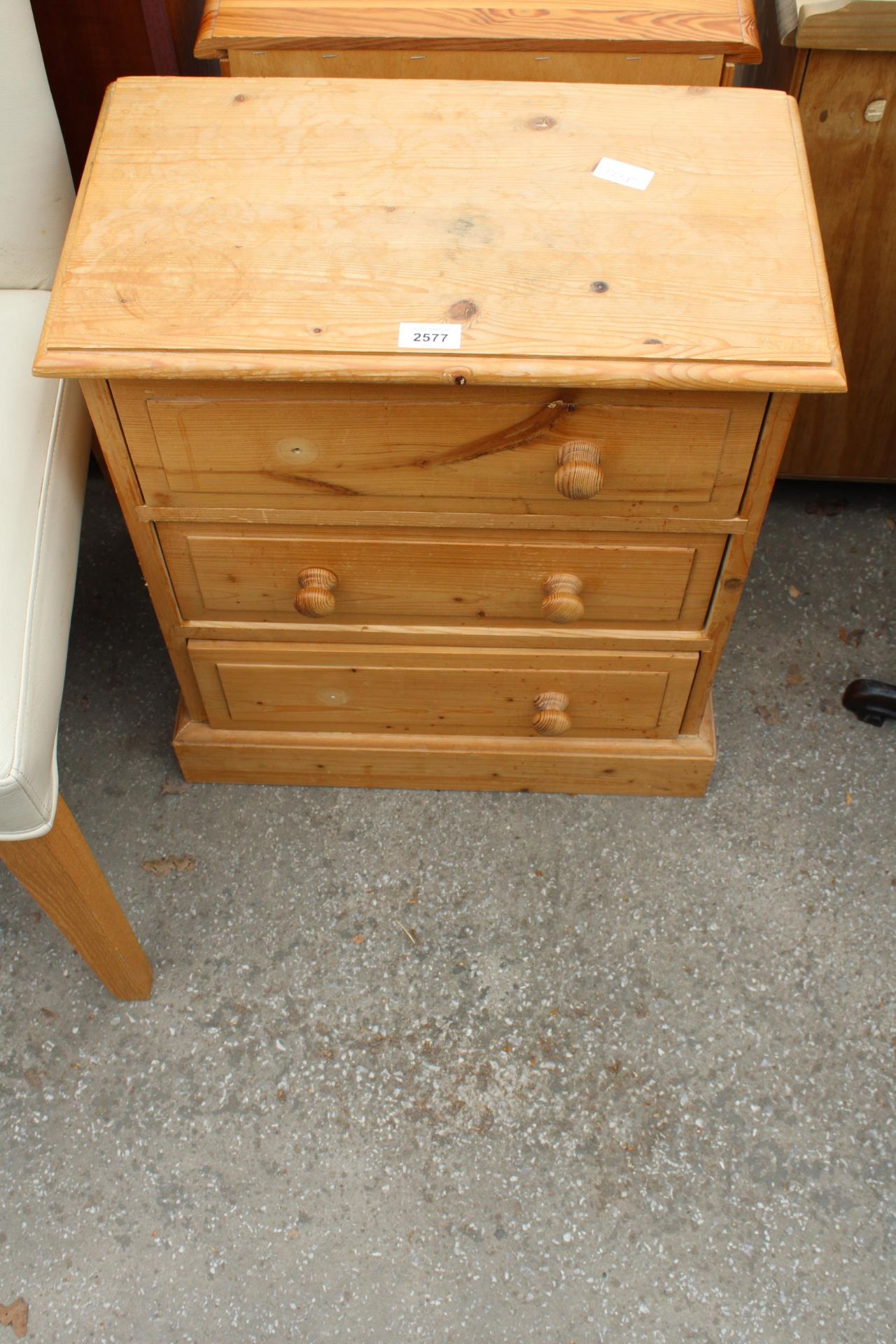 A PINE BEDSIDE CHEST OF THREE DRAWERS, 20" WIDE
