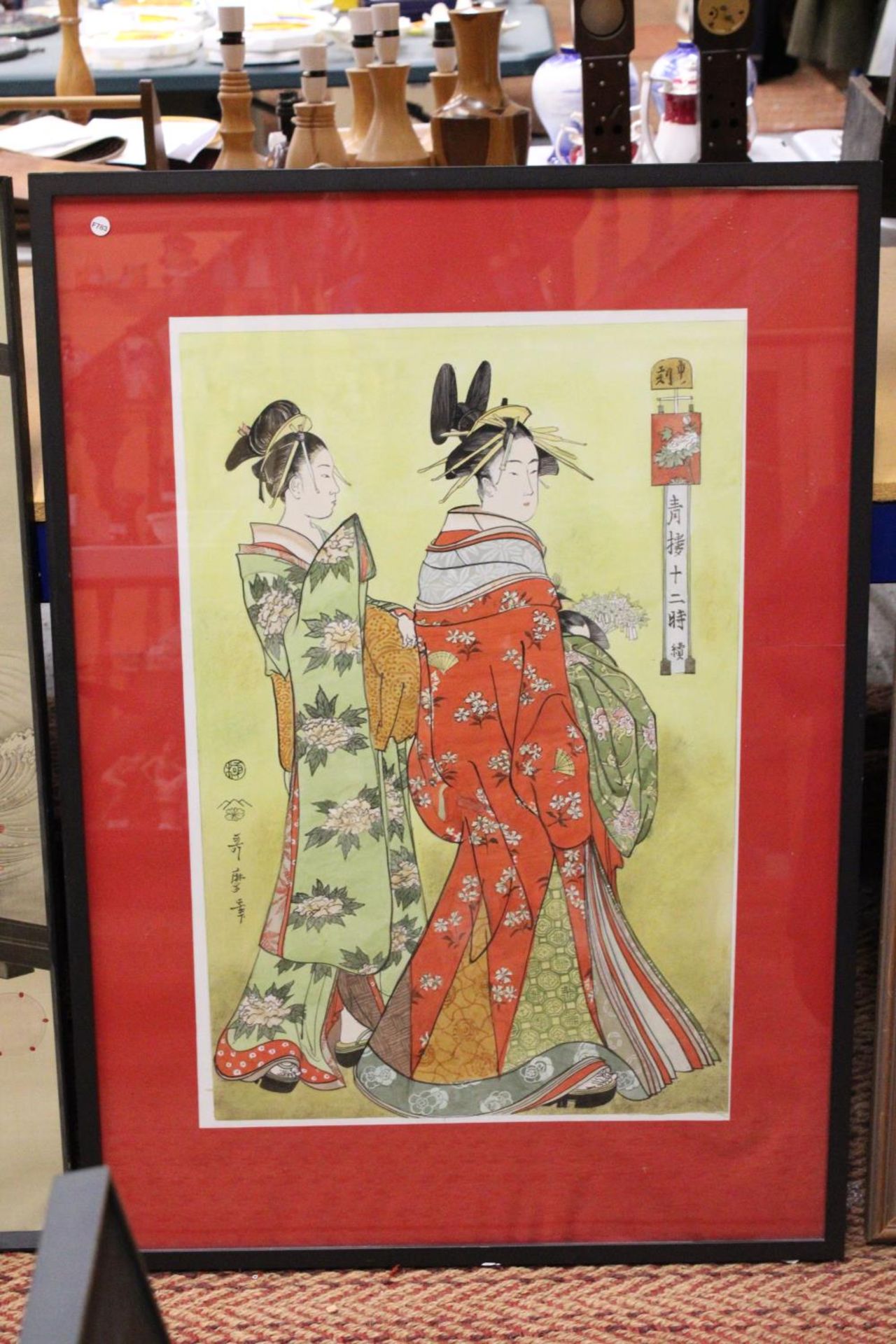 A JAPANESE WATERCOLOUR OF TWO GEISHA GIRLS FRAMED AND GLAZED - 75 CM X 50 CM