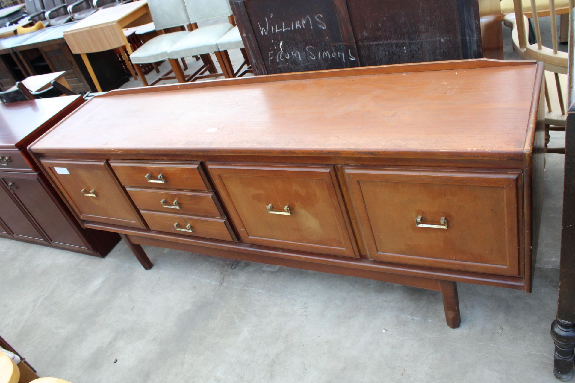 A RETRO TEAK SIDEBOARD ENCLOSING THREE DRAWERS AND THREE CUPBOARDS, 78" WIDE