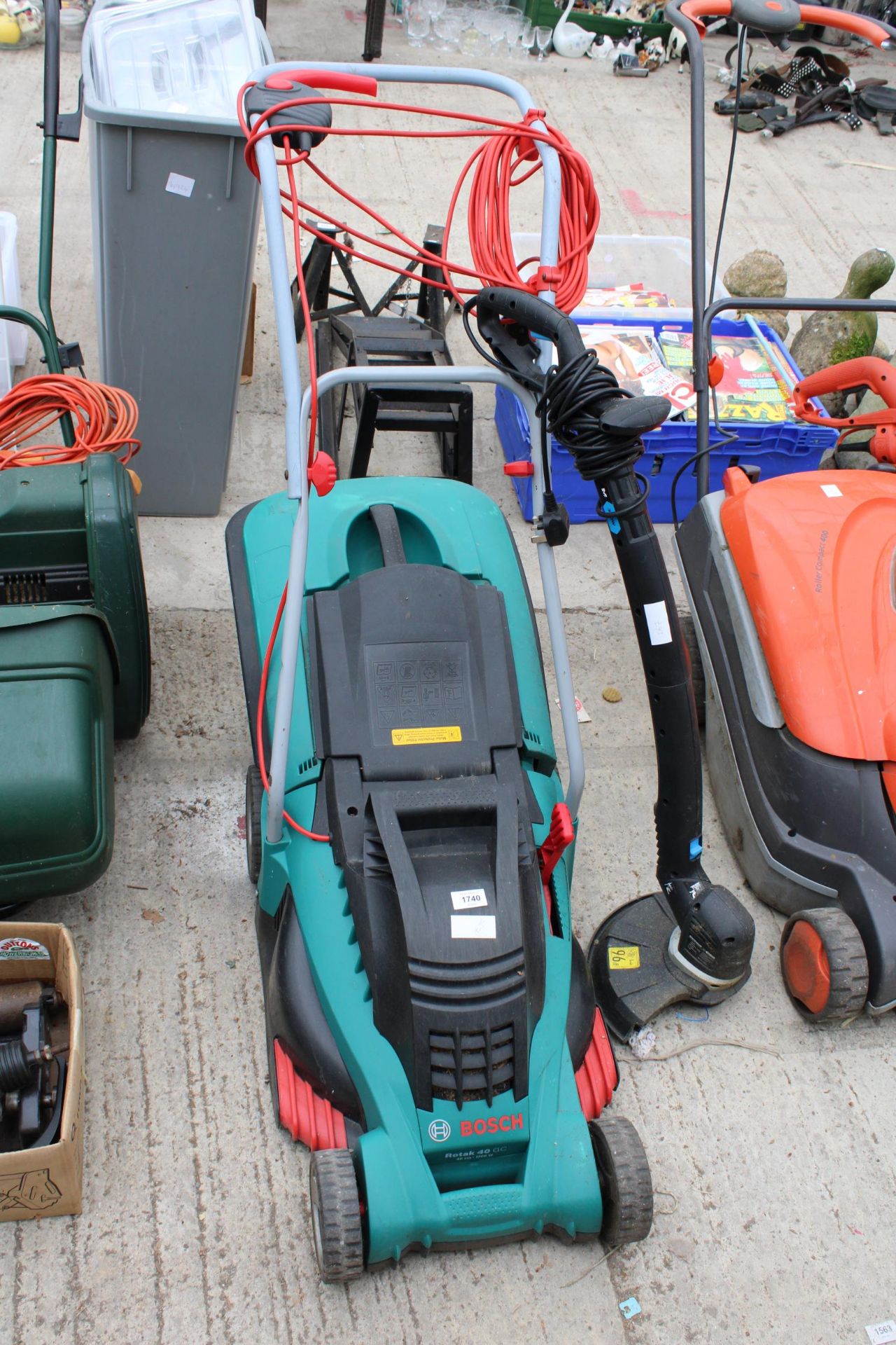 A BOSCH ELECTRIC LAWN MOWER AND A MACALLISTER ELECTRIC GRASS STRIMMER