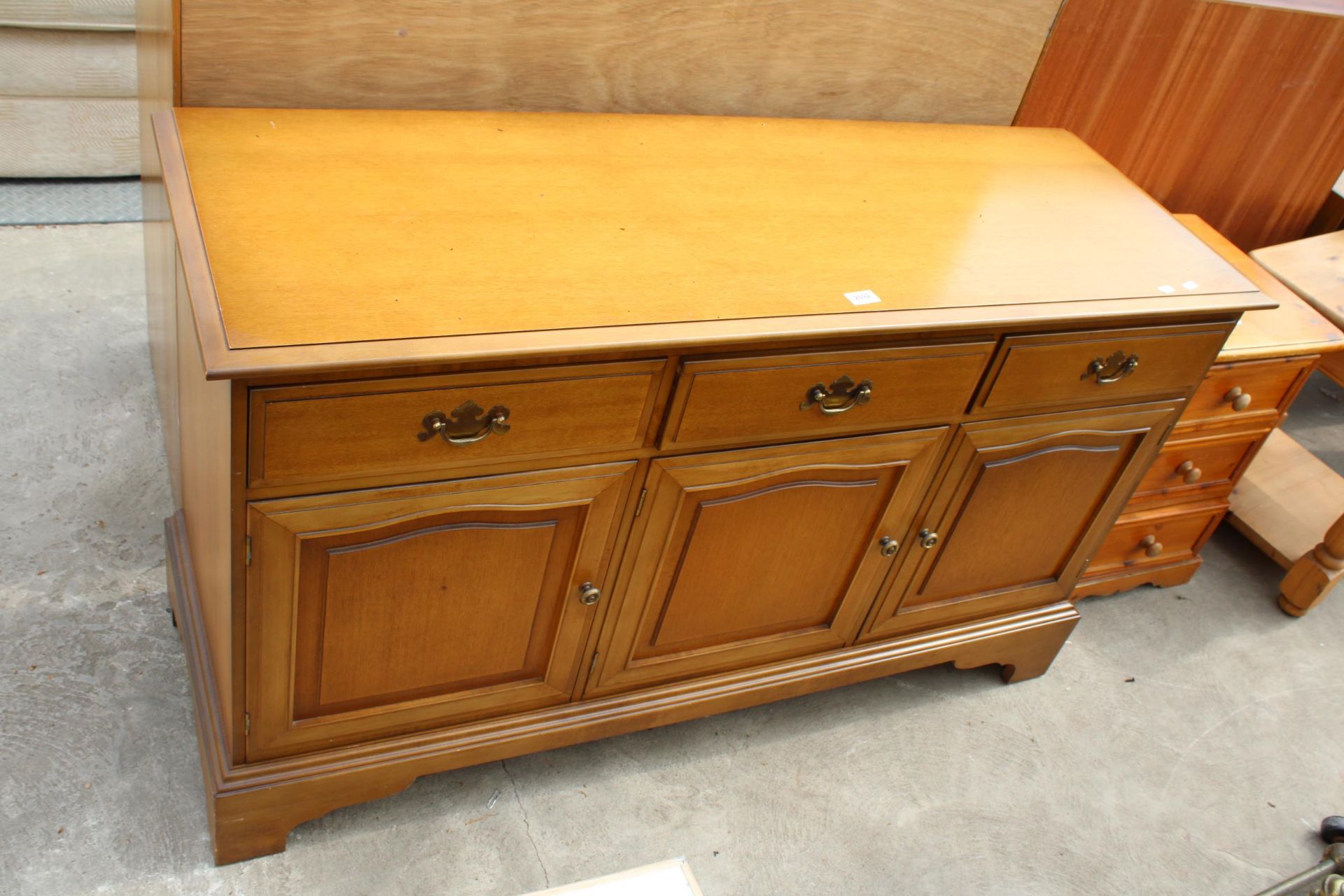 A MODERN STAG SIDEBOARD ENCLOSING THREE DRAWERS AND THREE CUPBOARDS, 52" WIDE