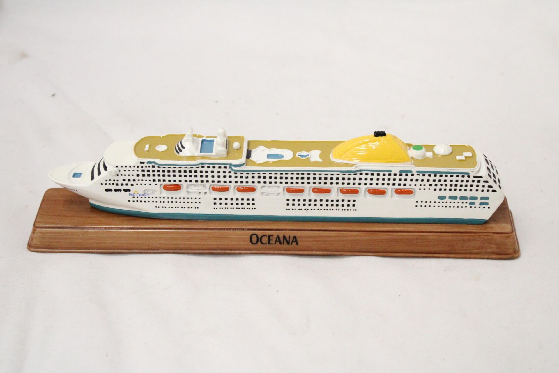 A HEAVY, SOLID, OCEAN LINER ON WOODEN STAND, 'OCEANA', LENGTH 27CM, HEIGHT 6CM