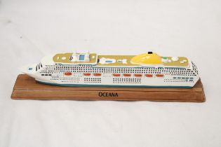 A HEAVY, SOLID, OCEAN LINER ON WOODEN STAND, 'OCEANA', LENGTH 27CM, HEIGHT 6CM