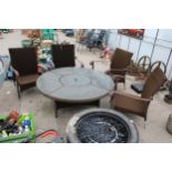 A GARDEN FURNITURE SET COMPRISING OF FOUR RATTAN CHAIRS AND A GRANITE TOP TABLE WITH FIRE PIT CENTRE