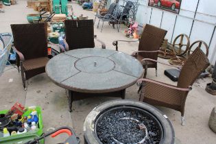 A GARDEN FURNITURE SET COMPRISING OF FOUR RATTAN CHAIRS AND A GRANITE TOP TABLE WITH FIRE PIT CENTRE