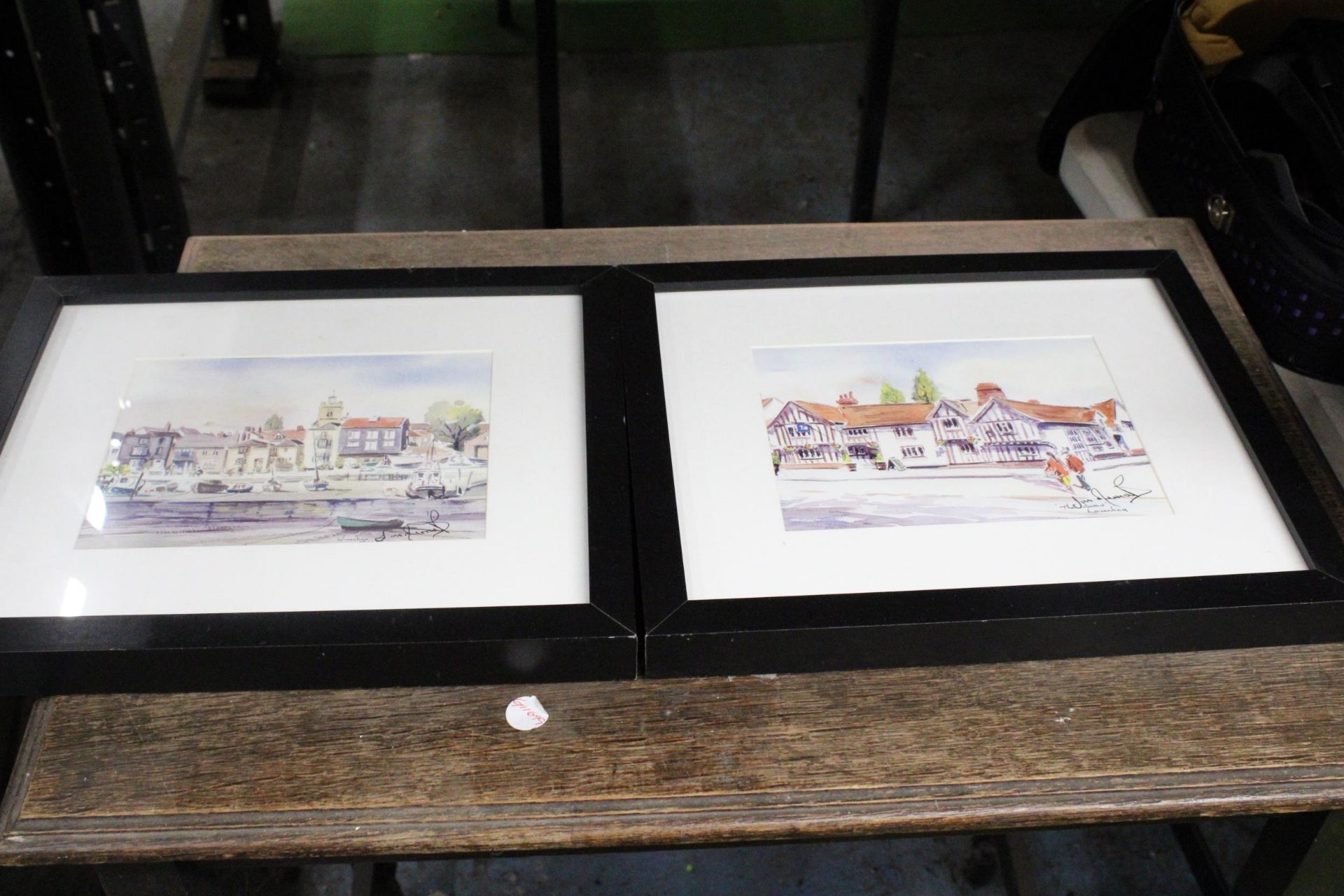 TWO FRAMED WATERCOLOURS ONE OF A BOATING SCENE AND THE OTHER A TOWN SCENE BOTH WITH SIGNATURES