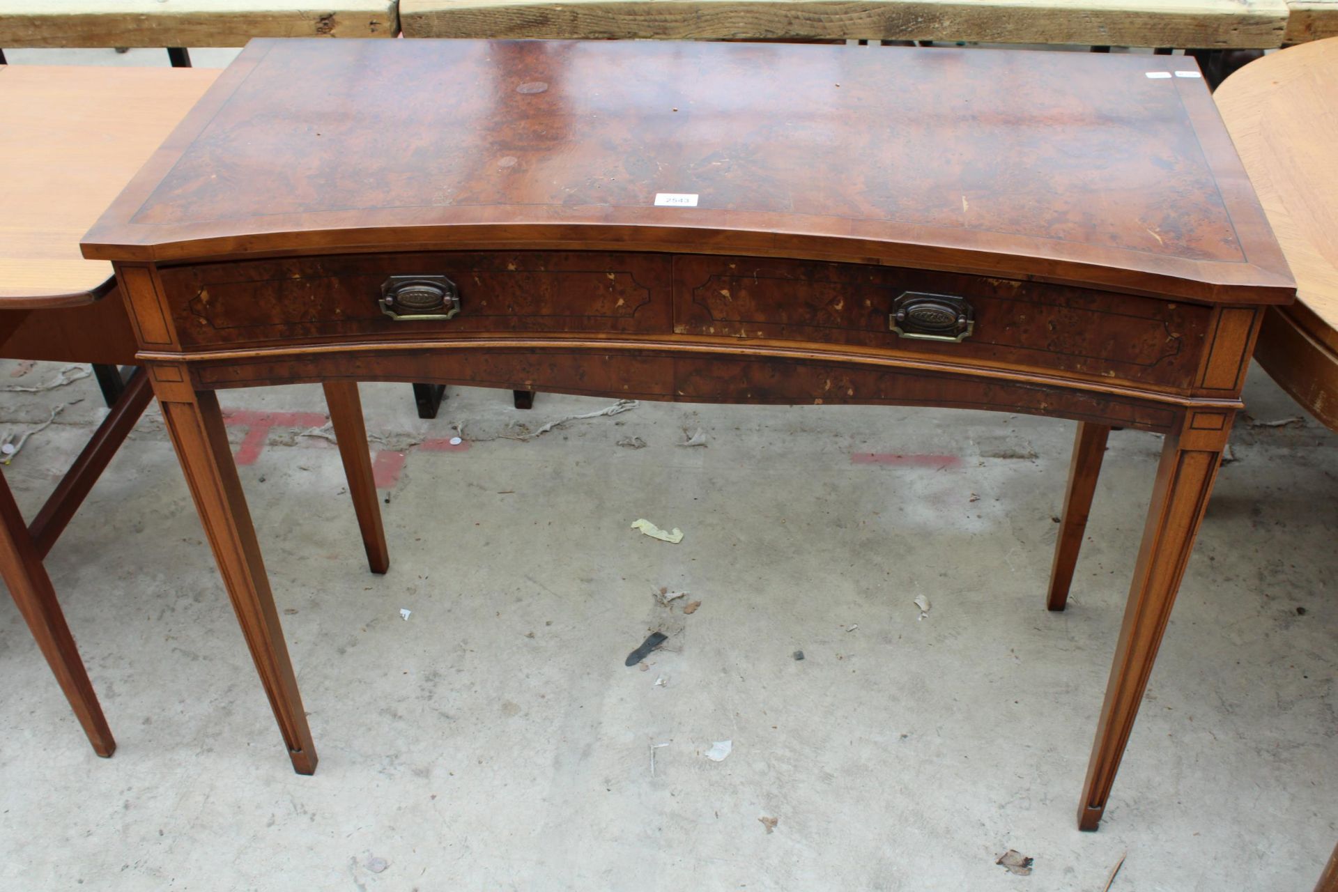 A REGENCY STYLE INVERTED BOW FRONTED SIDE TABLE WITH TWO DRAWERS ON TAPERING LEGS, 42" WIDE