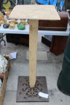 A WOODEN BIRD TABLE WITH DECORATIVE CAST IRON BASE