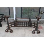 A VINTAGE CAST IRON FIRE GRATE WITH LARGE ATTATCHED FIRE DOGS