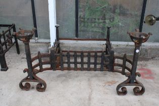 A VINTAGE CAST IRON FIRE GRATE WITH LARGE ATTATCHED FIRE DOGS