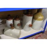 FOUR STONEWARE HOT WATER BOTTLES PLUS A STONEWARE FLAGON HOLT