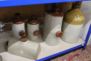 FOUR STONEWARE HOT WATER BOTTLES PLUS A STONEWARE FLAGON HOLT