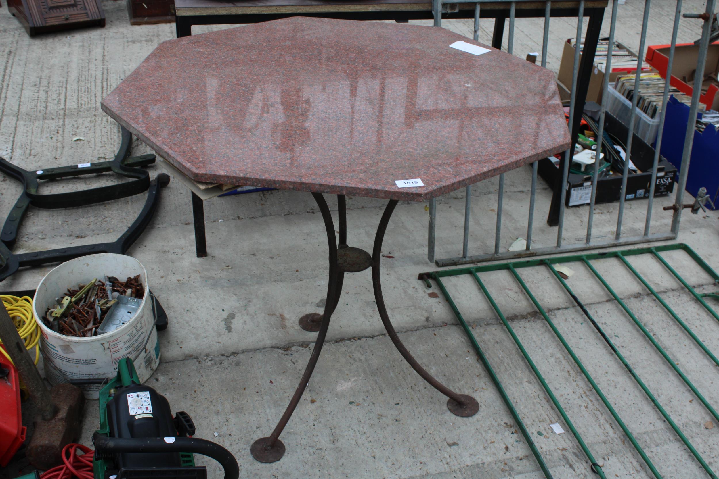 A GRANITE TOP METAL FRAMED BISTRO TABLE