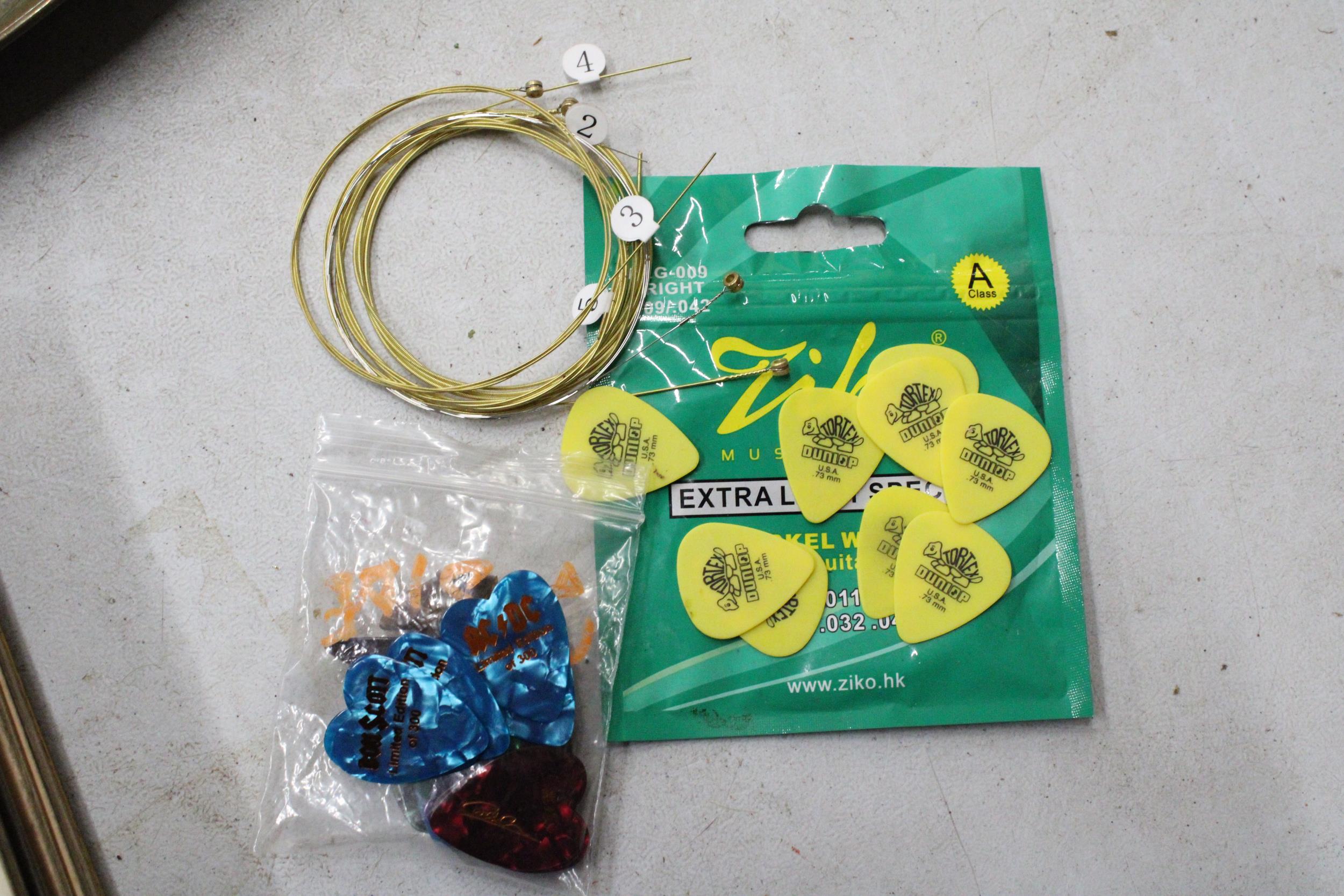 A QUANTITY OF ELECTRIC GUITAR STRINGS AND PLECTRUMS