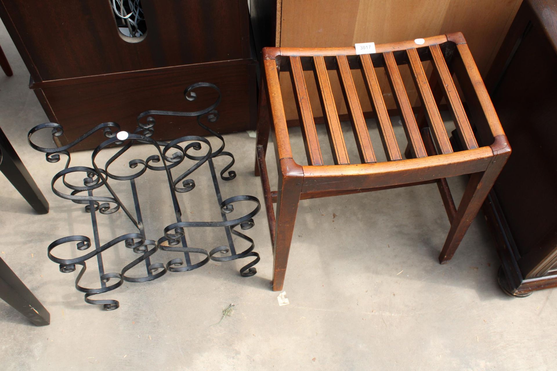 A 19TH CENTURY MAHOGANY SLATTED STOOL AND TWO DIVISION WROUGHT IRON MAGAZINE RACK