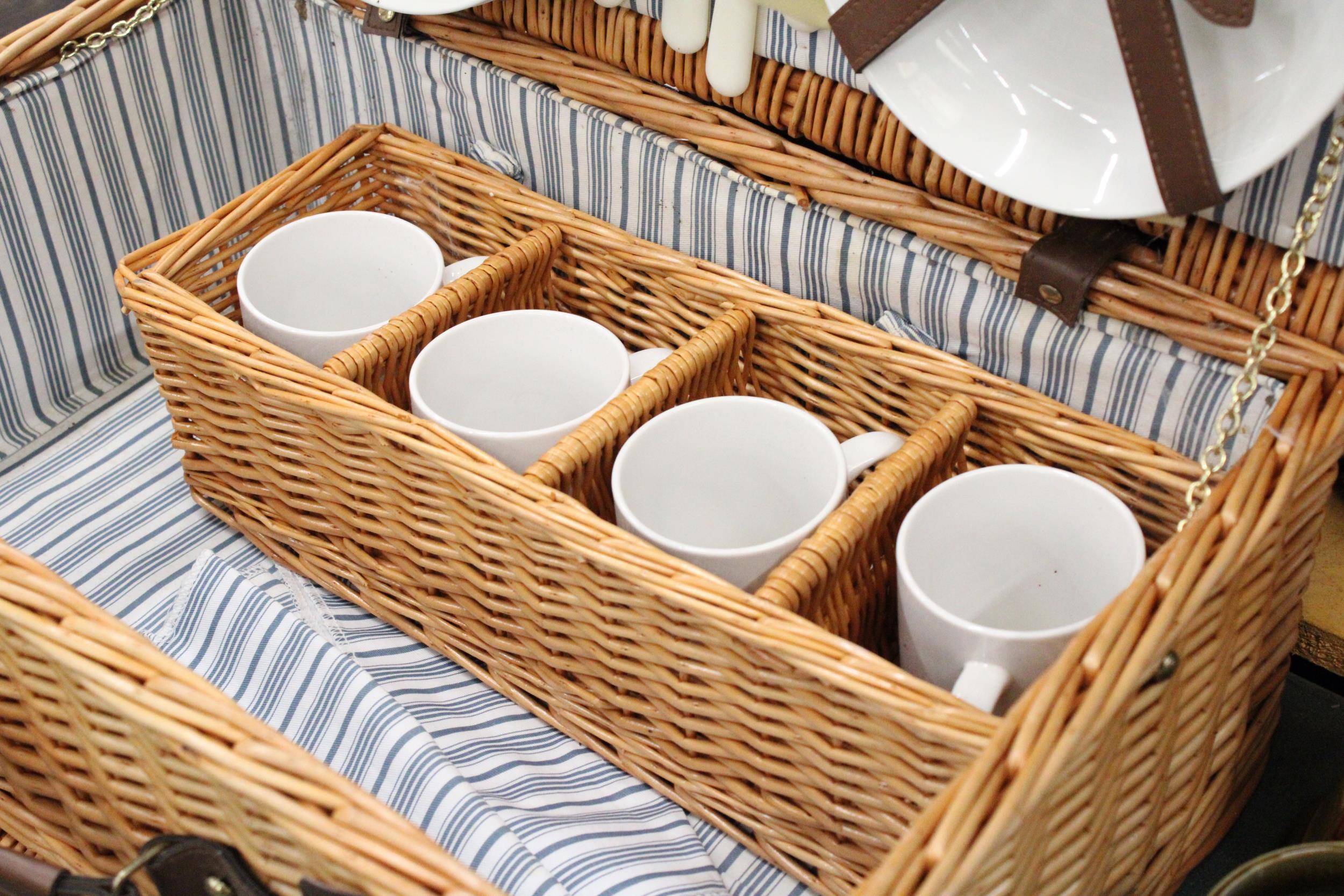 A LARGE WICKER PICNIC HAMPER CONTAINING CERAMIC CUPS AND PLATES, PLUS CUTLERY, A BOTTLE OPENER AND - Image 4 of 5