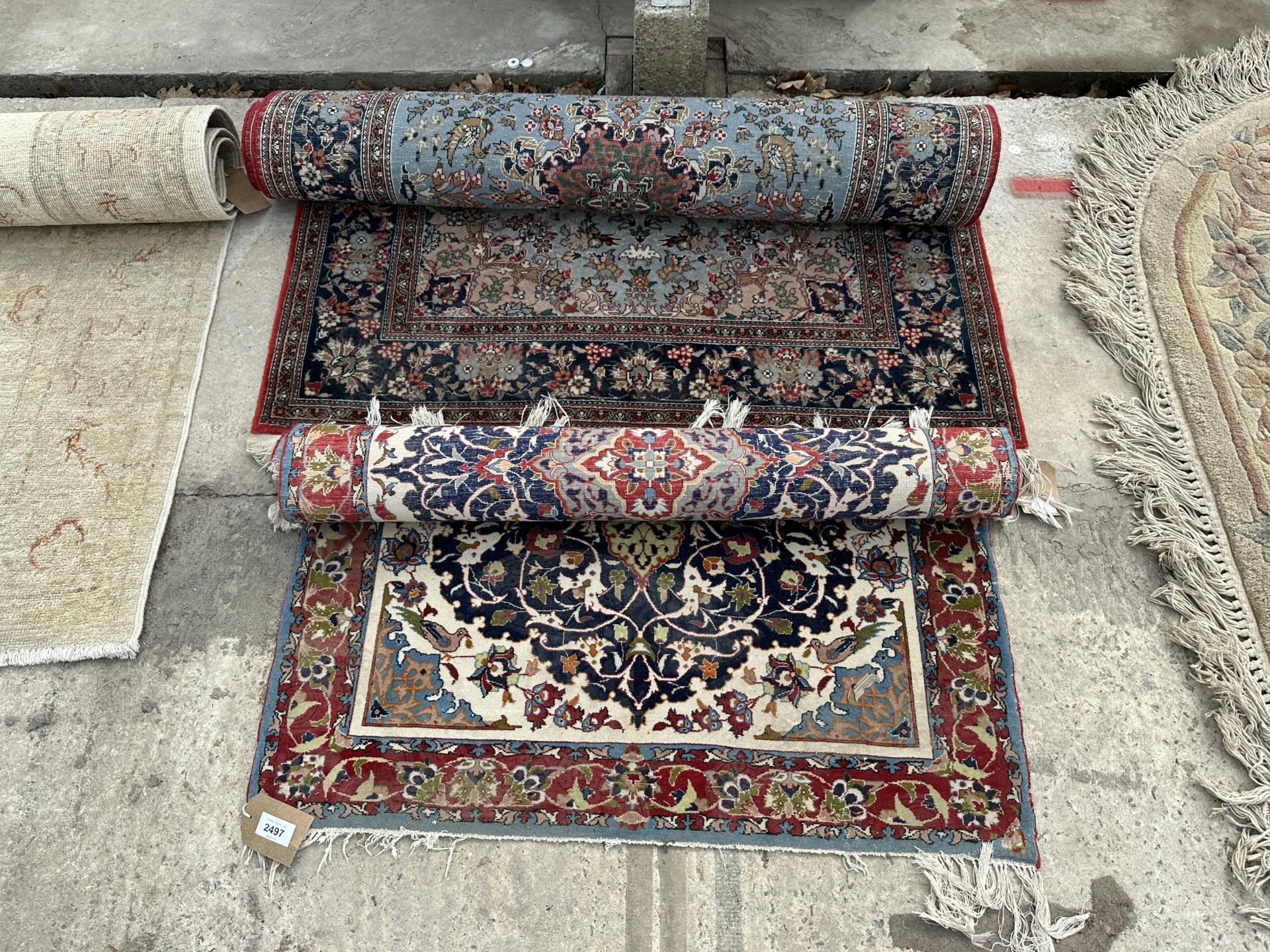 TWO SMALL RED PATTERNED FRINGED RUGS