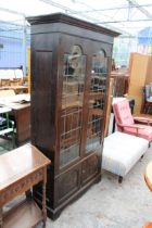 AN OAK ART NOUVEAU GLAZED AND LEADED TWO DOOR DISPLAY CABINET WITH CUPBOARDS TO BASE, 41" WIDE,