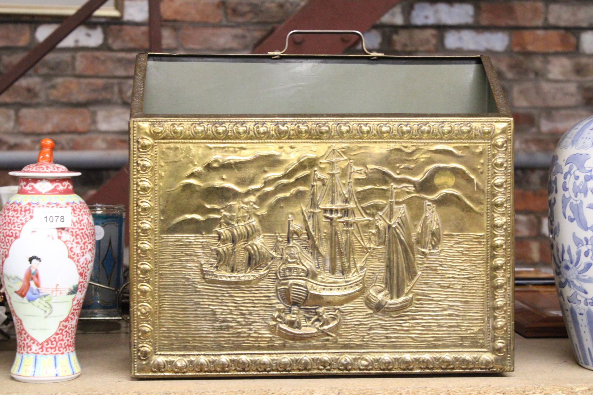 A VINTAGE BRASS MAGAZINE RACK WITH GALLEONS IMAGE