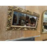 AN ORNATE GILT FRAMED MIRROR