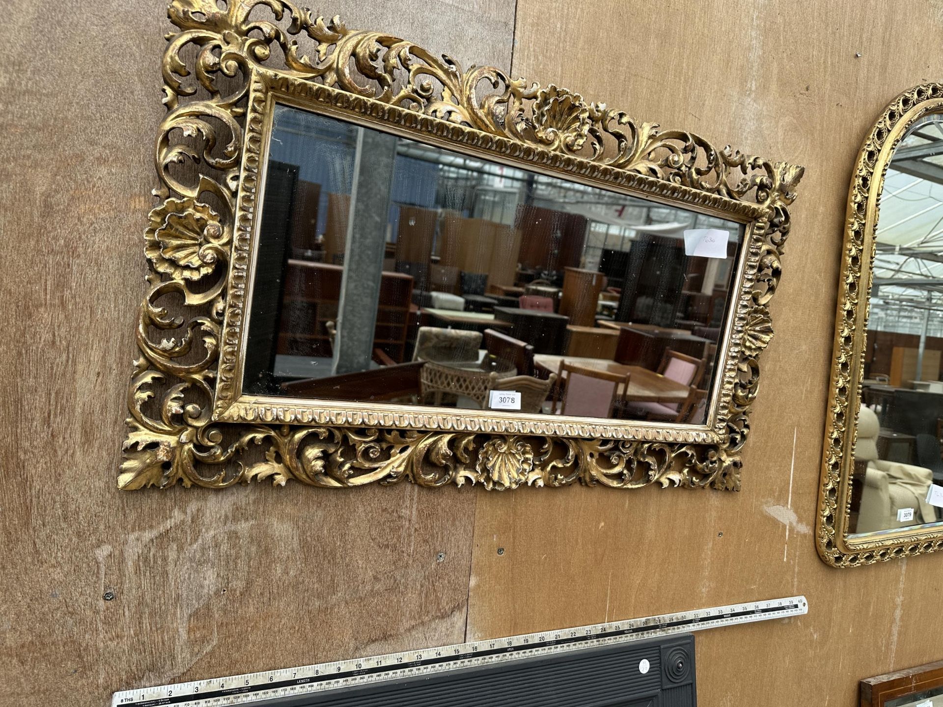 AN ORNATE GILT FRAMED MIRROR