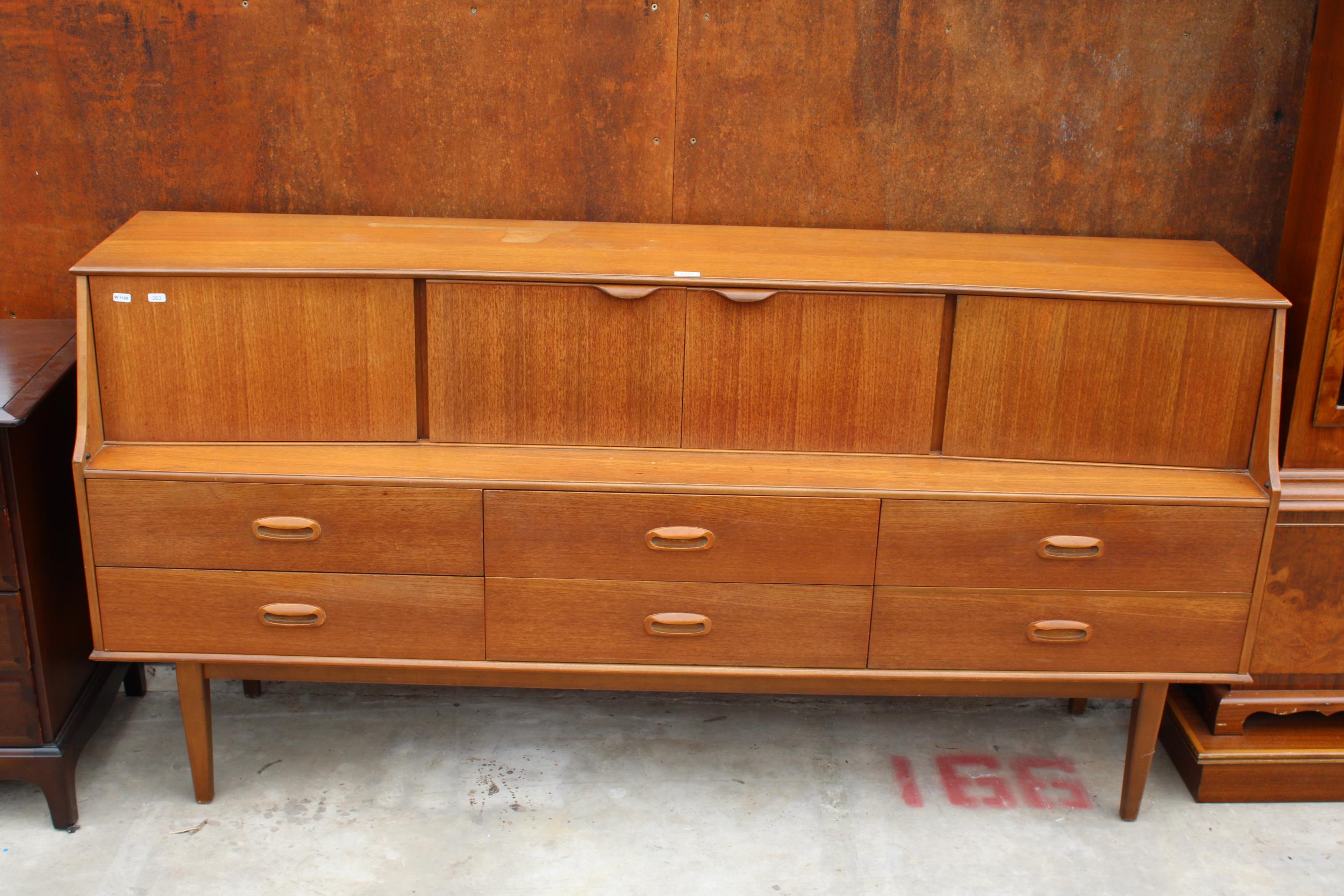 A RETRO TEAK PORTWOOD FURNITURE SIDEBOARD ENCLOSING SIX DRAWERS AND FOUR CUPBOARDS, 72" WIDE