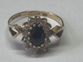 A 9 CARAT GOLD RING WITH SAPPHIRE AND CUBIC ZIRCONIAS