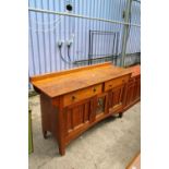 AN ART NOUVEAU OAK SIDEBOARD WITH CENTRAL EMBOSSED COPPER PANEL - 66" WIDE