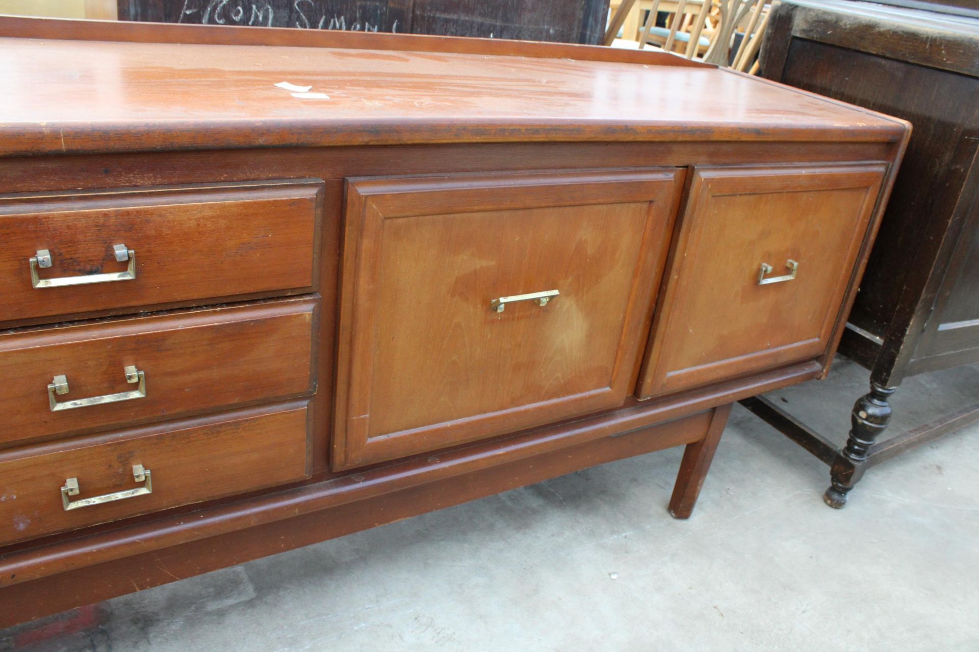 A RETRO TEAK SIDEBOARD ENCLOSING THREE DRAWERS AND THREE CUPBOARDS, 78" WIDE - Image 4 of 4