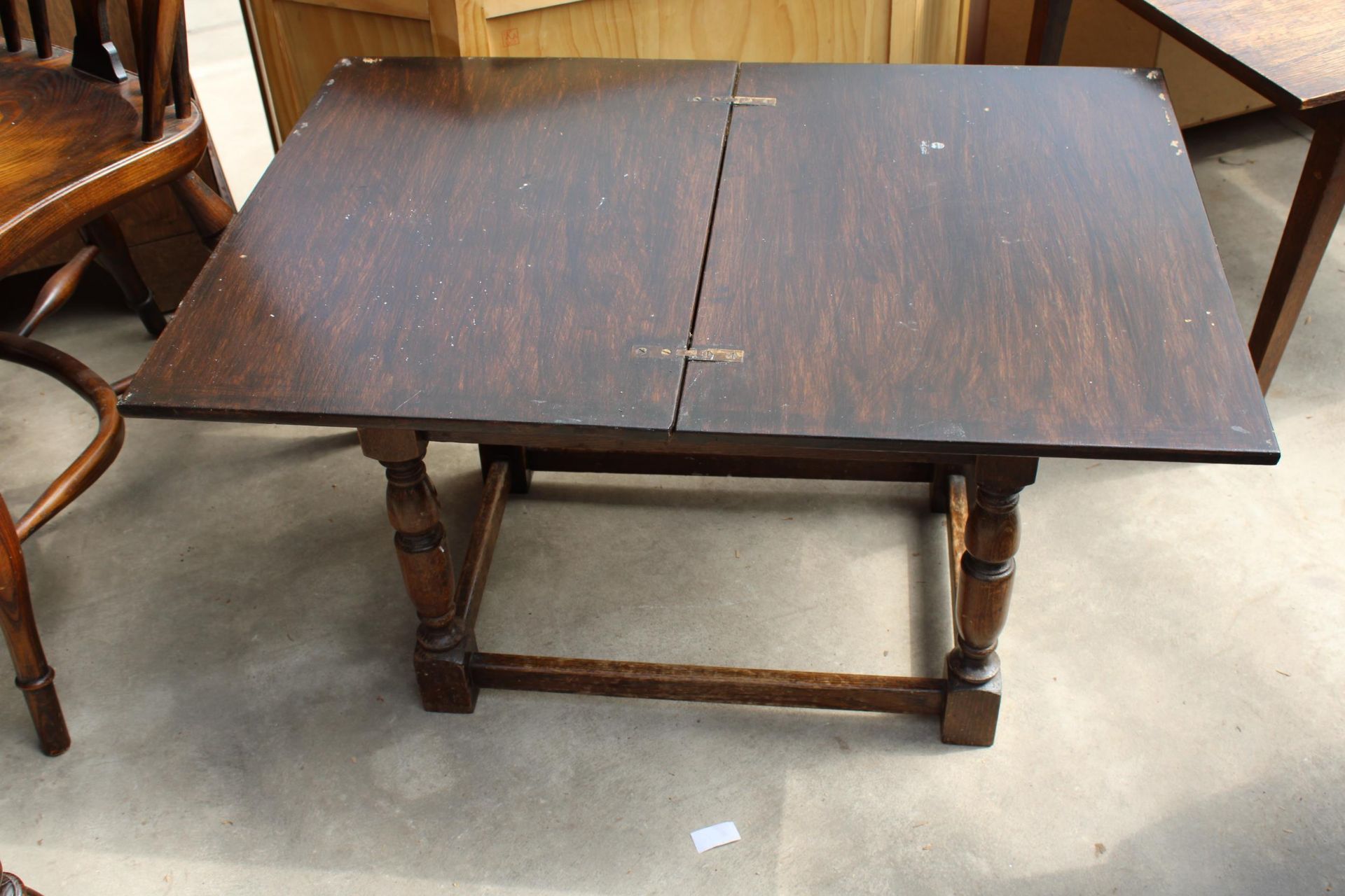 AN OAK JACOBEAN STYLE STOOL/TABLE WITH FOLD-OVER TOP